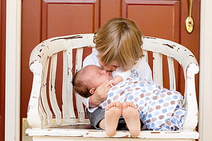 two babies on white wooden chair photo