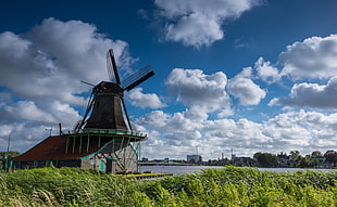 brown windmill under white cloudy sky during daytime HD wallpaper