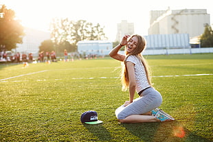woman wearing gray pants on green grass field
