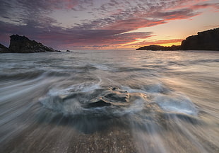 closeup photography of body of water near mountain at golden hour, porth, anglesey
