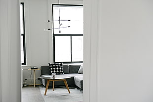 photo of white concrete wall and clear glass top  center table