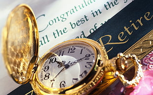 close up photo of gold pocket watch pointing at 10:20