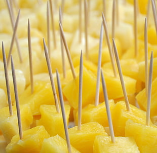 pineapple chunks on brown toothpick