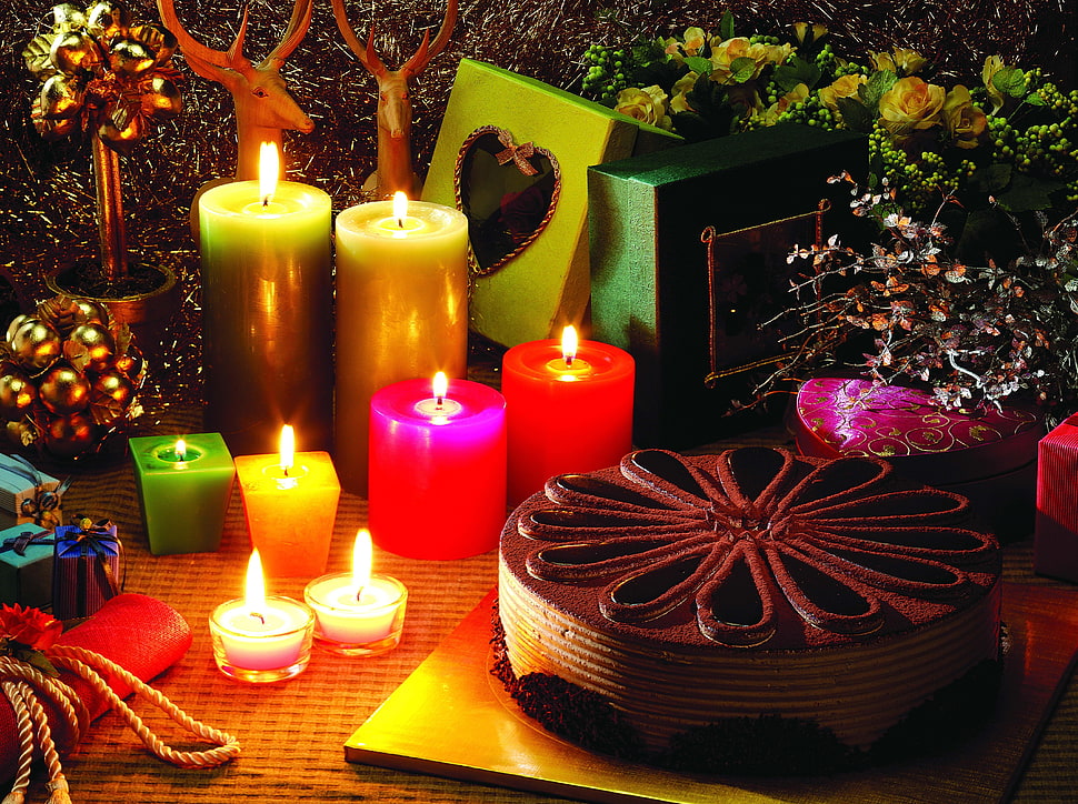 photography of round chocolate cake beside pillar candles HD wallpaper
