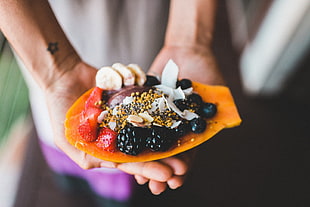 focus photo of papaya with blackberry and strawberry
