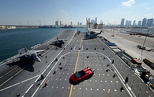 gray aircraft carrier near port