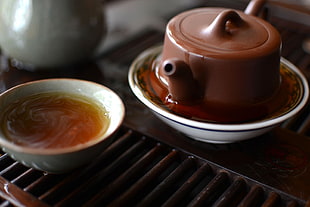 brown ceramic teapot, tea, bowls