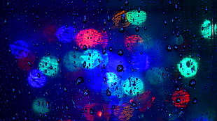 closeup photo of green, red, and blue lights with water drops