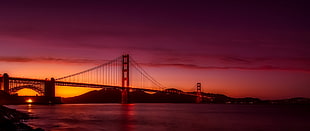 full suspension bridge above water during sunset HD wallpaper