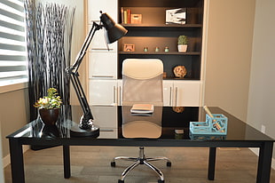 photo of rectangular black wooden desk with white rolling chair