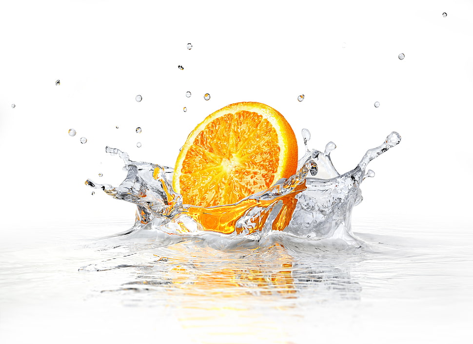 sliced orange fruit on water HD wallpaper