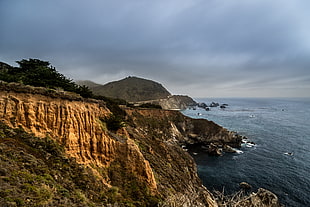 brown cliff near body of water, big sur