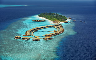 island with houses during daytime, resort, beach, island, sea