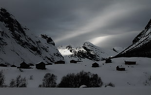 snow covered mountains with shade of sun on grayscale photography