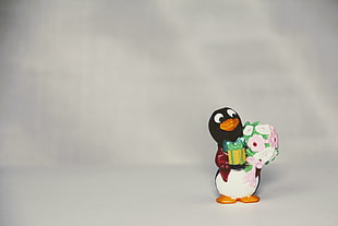 penguin holding gift box and flower ceramic figurine