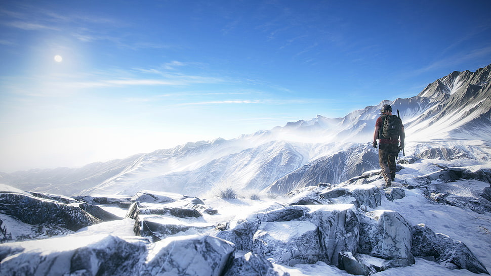 man standing on snow field mountain during daytime HD wallpaper