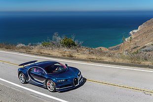 blue Bugatti Chiron car on road near coast on daytime HD wallpaper