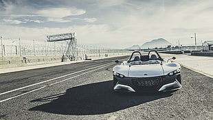 white sports car above gray concrete road