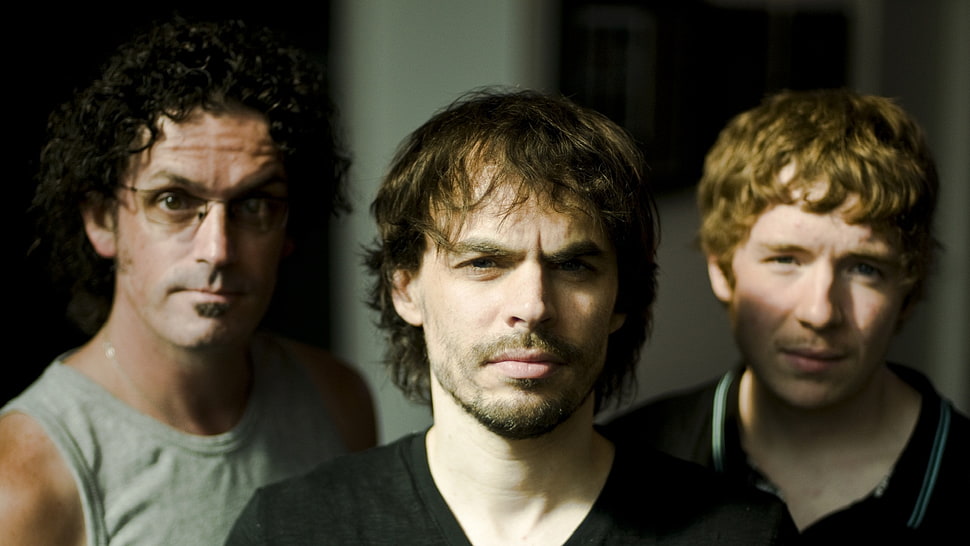 focused photo of three men HD wallpaper
