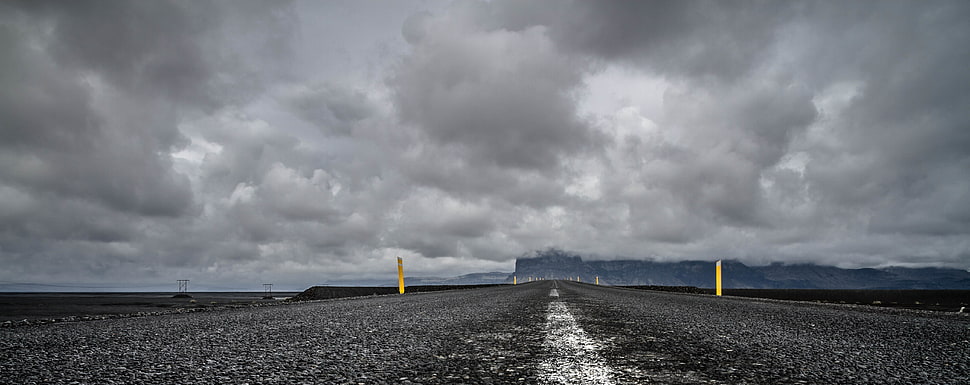 gray road under dark cloudy sky during daytime HD wallpaper