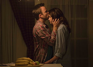 man kissing woman on forehead movie scene