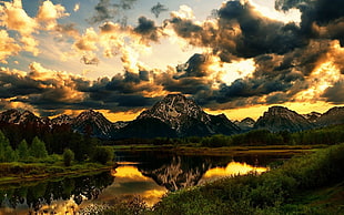 reflection of mountain on body of water HD wallpaper