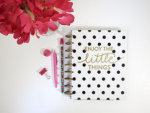Enjoy The Little Things printed notebook beside pens