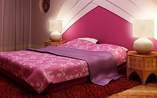 pink-and-white floral bed comforter near side table with table lamps