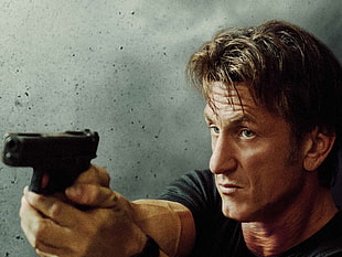 man holding pistol wearing black shirt HD wallpaper