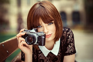 woman holding a film camera