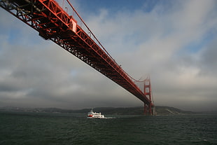white yatch passing below red metal bridge under cloudy sky, san francisco HD wallpaper