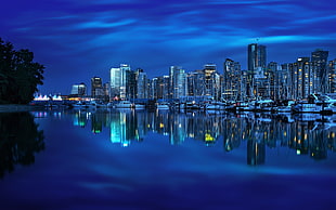 gray buildings, cityscape, night, water, river HD wallpaper