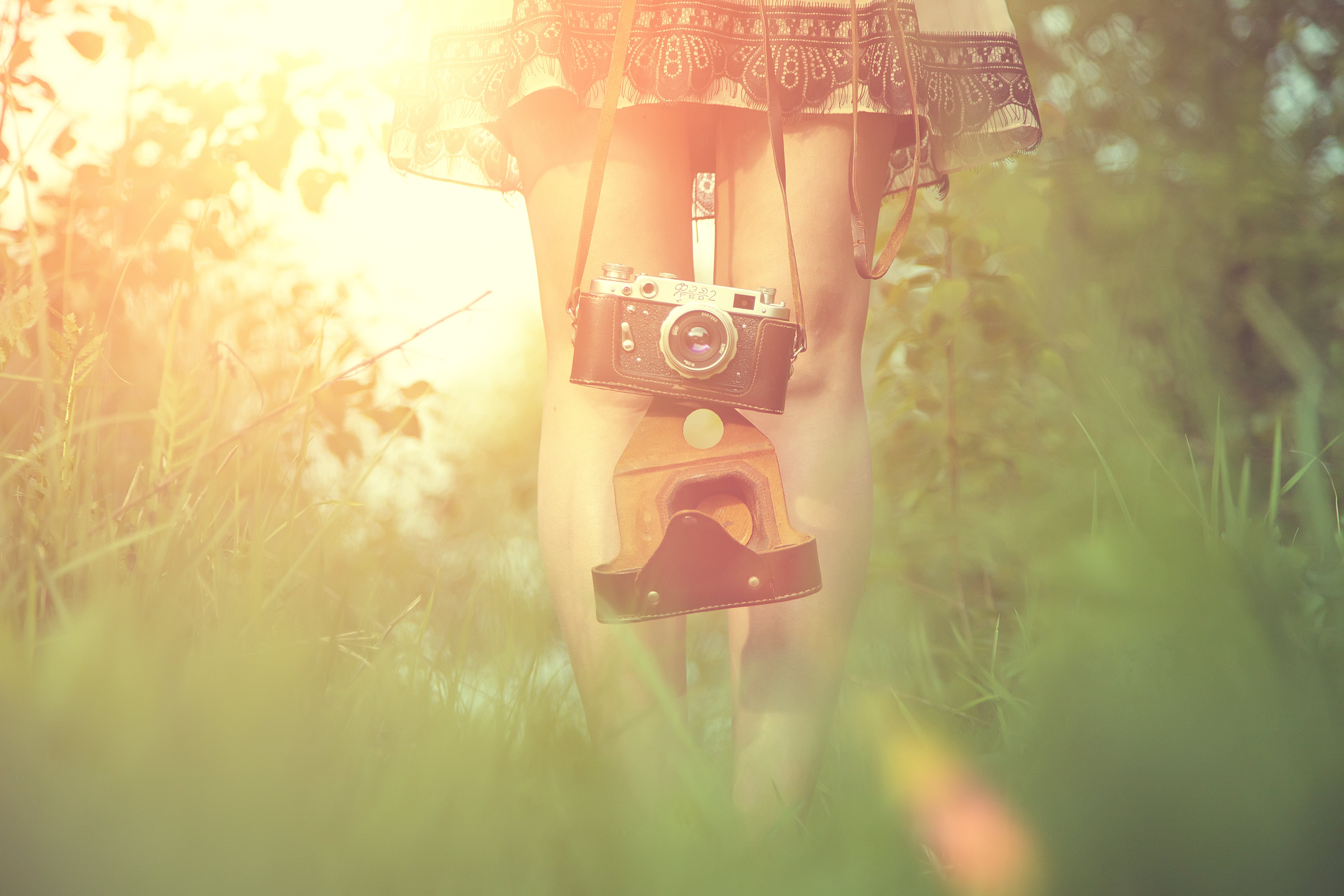 woman holding silver and black point and shoot camera