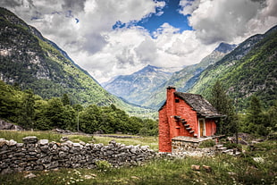 landscape photography of red concrete house facing tall mountains HD wallpaper