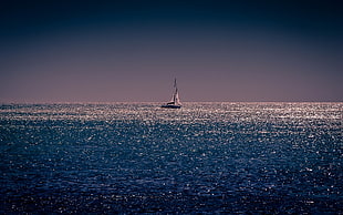 sailboat in the middle of the ocean