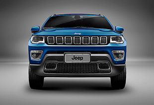 blue Jeep SUV with gray background