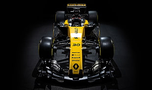 yellow Renault Formula 1 race car on black background