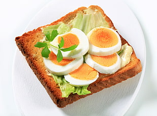 toast bread with boiled egg and lettuce on white ceramic plate HD wallpaper