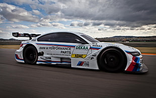 white, blue, and red BMW M-Series stock car