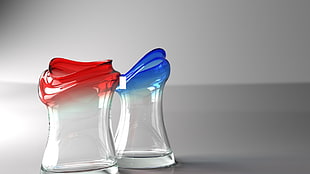 two clear glass containers, red, blue, simple background