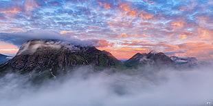 time lapse and HDR photography of mountain peak covered with clouds and fogs HD wallpaper