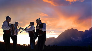 landscape photography of four musicians and mountain under clear sky during daytime
