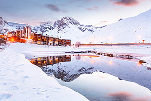 brown and white building during winter, mirror lake, tignes HD wallpaper