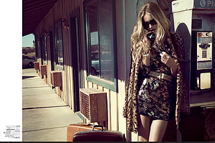 woman wearing black floral lace mini dress and brown fur coat