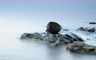 rocks surrounded by body of water