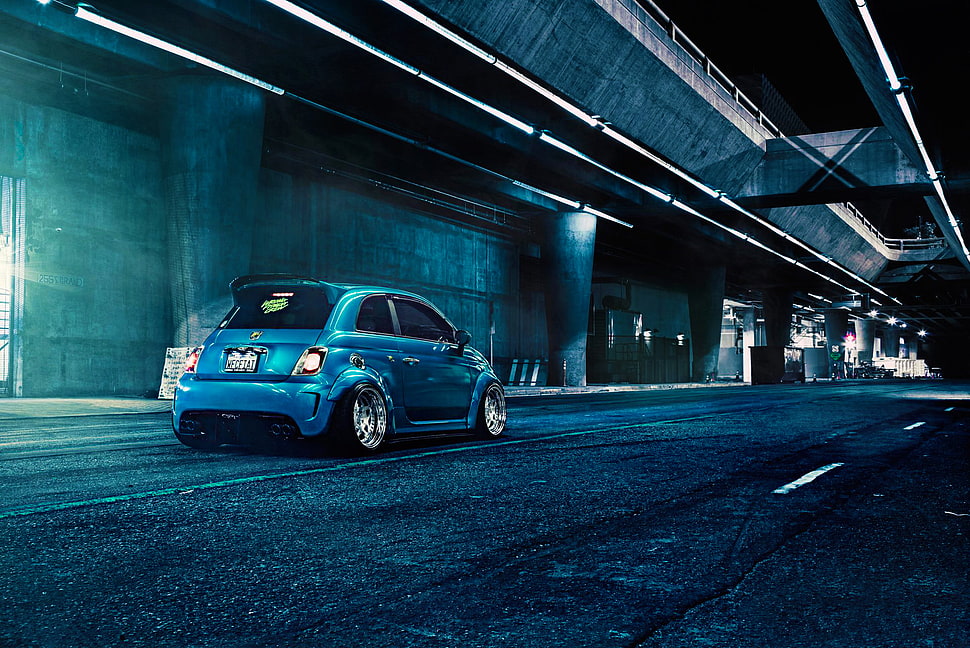 blue 5-door hatchback car on concrete roadway HD wallpaper