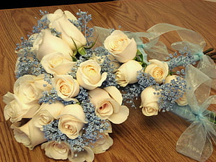 white Roses bouquet on brown wooden surface