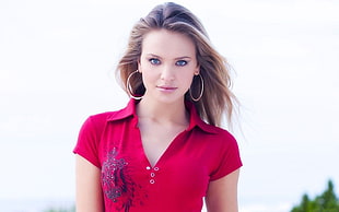 woman wearing red polo shirt while posing on camera HD wallpaper