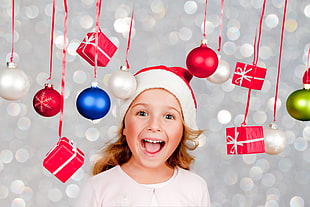 girl wearing christmas hat with christmas decors