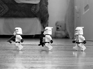 three white Lego mini figures on The floor